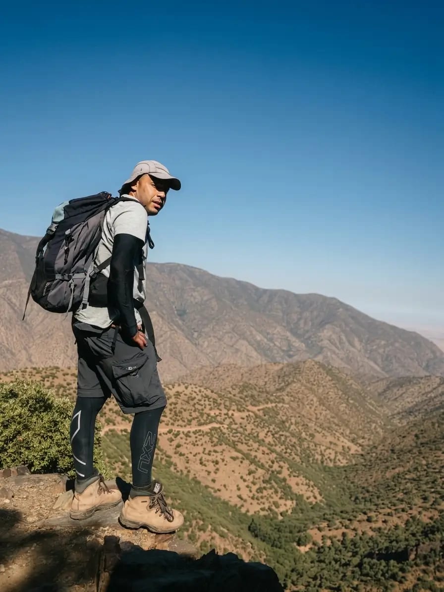 Hassan hiking through the Atlas Mountains with a backpack