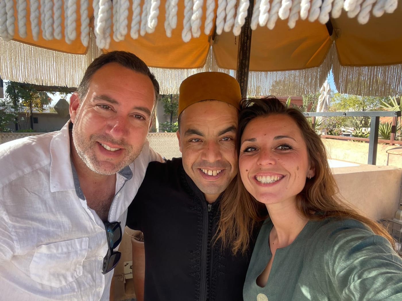 Hasy smiling with two guests during their journey in Morocco